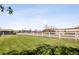 Spacious back yard offers a level grassy area with a white fence at 12941 W 75Th Ave, Arvada, CO 80005