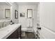 Well-lit bathroom with a modern vanity, white subway tile, and shower with curtain at 12941 W 75Th Ave, Arvada, CO 80005