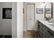 Bright bathroom with double vanities, stylish fixtures, white subway tile in the shower, and a decorative mosaic at 12941 W 75Th Ave, Arvada, CO 80005