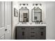 Modern bathroom features double vanities, stylish fixtures, decorative mirrors, and convenient storage space at 12941 W 75Th Ave, Arvada, CO 80005