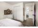 Bright bedroom shows the entry door, closet and the dresser with bird cage at 12941 W 75Th Ave, Arvada, CO 80005