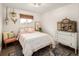 A cozy bedroom features charming decor, a comfortable bed, and a peaceful ambiance at 12941 W 75Th Ave, Arvada, CO 80005