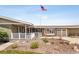Inviting front porch featuring a wooden deck, brick accents, and mature landscaping at 12941 W 75Th Ave, Arvada, CO 80005
