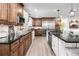 Modern kitchen with stainless steel appliances, granite countertops, and island seating at 12941 W 75Th Ave, Arvada, CO 80005