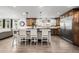 Stylish kitchen island with seating, stainless steel appliances, and a large refrigerator at 12941 W 75Th Ave, Arvada, CO 80005