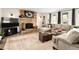 Cozy living room featuring a stone fireplace, plush seating, and ample natural light at 12941 W 75Th Ave, Arvada, CO 80005