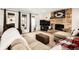 Bright living room featuring a stone fireplace, neutral furnishings, hardwood flooring, and plenty of natural light at 12941 W 75Th Ave, Arvada, CO 80005