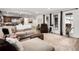 Open-concept living area with hardwood floors, bright windows, modern furnishings, and seamless access to the kitchen at 12941 W 75Th Ave, Arvada, CO 80005