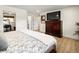 Well-lit main bedroom with a wooden dresser, hardwood floors, and doorways to adjacent spaces in the home at 12941 W 75Th Ave, Arvada, CO 80005