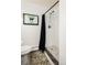 Modern shower with unique tile flooring, clean white walls, and stylish fixtures for a luxurious experience at 12941 W 75Th Ave, Arvada, CO 80005