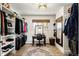 Spacious walk-in closet with custom shelving, desk, and ample storage for clothes and accessories at 12941 W 75Th Ave, Arvada, CO 80005