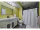 Bathroom with unique light green walls, a modern basin sink, and tiled shower at 4896 S Dudley St # 5-5, Littleton, CO 80123