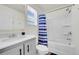 Bright bathroom with a shower-tub combination, a modern vanity, and a window at 18284 E 49Th Pl, Denver, CO 80249