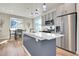 Modern kitchen featuring stainless steel appliances, a central island, and pendant lighting at 18284 E 49Th Pl, Denver, CO 80249