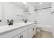 Bathroom featuring dual sinks, white cabinetry, and modern fixtures at 39181 Anthony St, Elizabeth, CO 80107