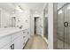 Bright bathroom with a double sink vanity, a walk-in shower and a separate toilet room at 39181 Anthony St, Elizabeth, CO 80107