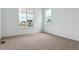 Bright, carpeted bedroom with two windows providing ample natural light at 39181 Anthony St, Elizabeth, CO 80107
