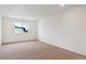 A bedroom with neutral carpet and a window with a neighborhood view at 39181 Anthony St, Elizabeth, CO 80107