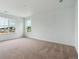 An empty bedroom with neutral carpet and two windows to let in natural light at 39181 Anthony St, Elizabeth, CO 80107