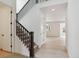 Bright entryway with hardwood floors leads to a staircase with dark wood banister and white risers at 39181 Anthony St, Elizabeth, CO 80107