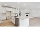 Modern kitchen with large island, stainless steel appliances, and sleek countertops at 39181 Anthony St, Elizabeth, CO 80107