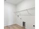 An empty laundry room with wood floors and wire shelf above hookups at 39181 Anthony St, Elizabeth, CO 80107