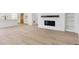 Open concept living room with hardwood floors, fireplace, and seamless kitchen access at 39181 Anthony St, Elizabeth, CO 80107