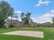 Community basketball court on expansive green lawn with surrounding townhome exteriors at 7700 W Glasgow Place # 15A, Littleton, CO 80128