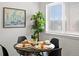 Bright dining area features a table for four with modern decorations at 7700 W Glasgow Place # 15A, Littleton, CO 80128