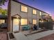 Tan two-story townhome with private patio, grill, and landscaping at 7700 W Glasgow Place # 15A, Littleton, CO 80128