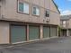 Exterior view of a row of green garages with parking spaces at 7700 W Glasgow Place # 15A, Littleton, CO 80128