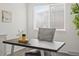 Bright home office space with a large window, modern desk, and comfortable chair at 7700 W Glasgow Place # 15A, Littleton, CO 80128