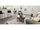 Bright living space with neutral decor, modern seating and barstools at 7700 W Glasgow Place # 15A, Littleton, CO 80128
