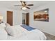 Inviting main bedroom with ceiling fan, ensuite access and a scenic art piece at 7700 W Glasgow Place # 15A, Littleton, CO 80128