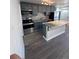 A modern kitchen featuring gray cabinets, stainless appliances and a granite island at 4665 W 6Th Ave # 21, Denver, CO 80204