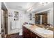 Elegant bathroom with dual sinks, granite countertop, and a glass-enclosed shower at 8100 E Union Ave # 712, Denver, CO 80237
