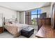 Comfortable bedroom with a large window providing natural light and city views at 8100 E Union Ave # 712, Denver, CO 80237