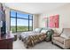 Cozy bedroom with a large window offering beautiful views and a comfortable sofa bed at 8100 E Union Ave # 712, Denver, CO 80237