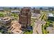 Elegant high-rise condominium with a brick facade, street-level access, and lush landscaping at 8100 E Union Ave # 712, Denver, CO 80237