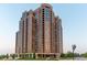 Beautiful high-rise building exterior with balconies and lush landscaping surrounding the entrance at 8100 E Union Ave # 712, Denver, CO 80237