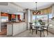 Modern kitchen seamlessly connects with the dining area, enhanced by a stylish chandelier and ample natural light at 8100 E Union Ave # 712, Denver, CO 80237