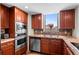 Well-appointed kitchen features stainless steel appliances, granite countertops, and warm wood cabinetry at 8100 E Union Ave # 712, Denver, CO 80237