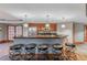 Modern kitchenette featuring stainless steel appliances, bar seating, and stylish pendant lighting at 8100 E Union Ave # 712, Denver, CO 80237