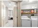 Bright laundry room with washer, dryer, and shelving for organization at 8100 E Union Ave # 712, Denver, CO 80237