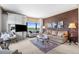 Well-appointed living room features stylish decor, comfortable seating, and large windows offering natural light at 8100 E Union Ave # 712, Denver, CO 80237
