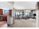 Open-concept living space with a modern chandelier, expansive windows, and seamless flow to the kitchen at 8100 E Union Ave # 712, Denver, CO 80237