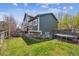 Spacious back yard with a grassy area, a patio, and a trampoline with a privacy fence at 11072 Quail Ct, Parker, CO 80134