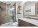 Bathroom with a glass shower, floating wood shelves and a granite countertop and backsplash at 11072 Quail Ct, Parker, CO 80134