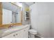 Bathroom featuring a wood frame mirror, a light colored vanity, and a shower with tile surround at 11072 Quail Ct, Parker, CO 80134