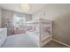 Cozy bedroom with a bunk bed, large window, and a small reading nook with storage at 11072 Quail Ct, Parker, CO 80134